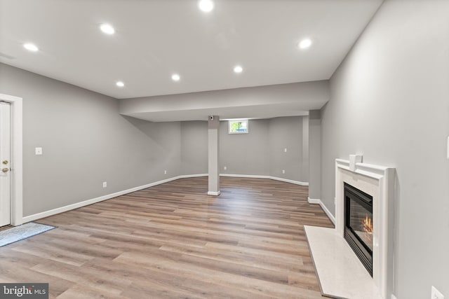 18729 Upper Meadow Dr, Leesburg, VA 20176 - below grade area with light wood-style floors, a premium fireplace, baseboards, and recessed lighting