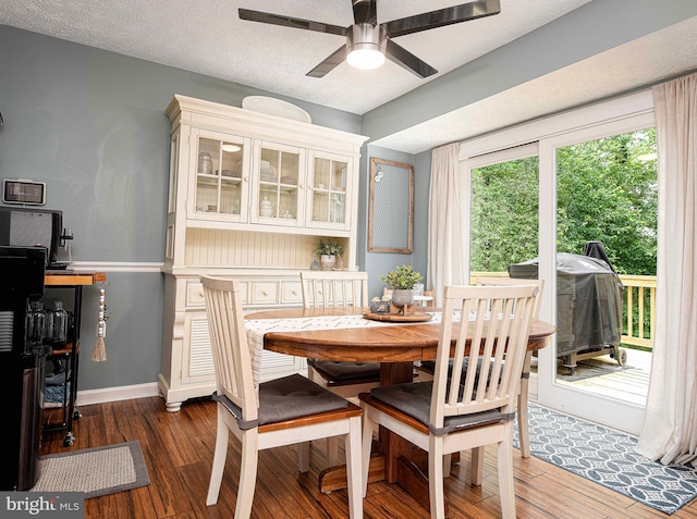 dining room with ceiling fan, wood finished floors, and baseboards