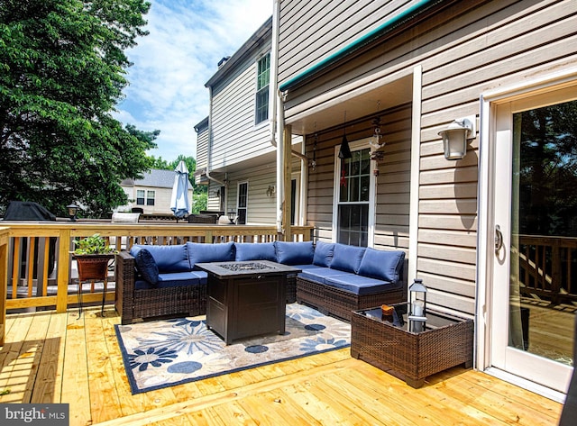 wooden deck with an outdoor living space with a fire pit