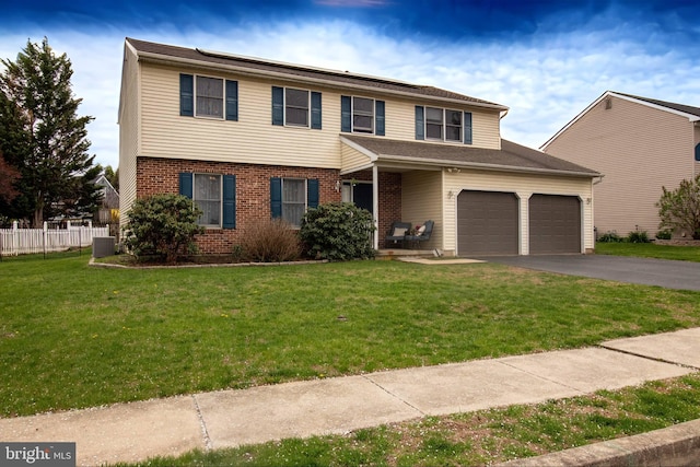 view of front facade featuring asphalt driveway, brick siding, and a garage