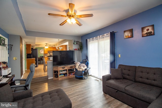 living room featuring a ceiling fan and light wood-style floors