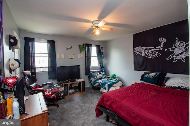 bedroom with multiple windows, carpet flooring, and a ceiling fan