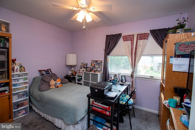 carpeted bedroom with baseboards and ceiling fan