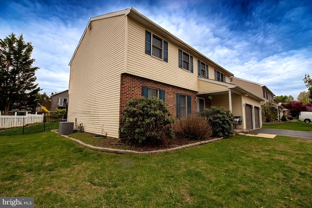 view of side of home featuring brick siding, driveway, and central air condition unit