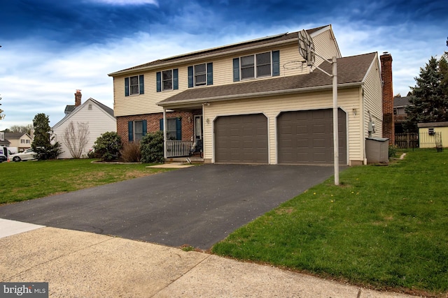 view of front of home featuring driveway, a front lawn, and a garage