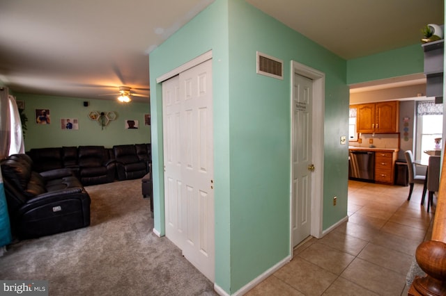 living room with ceiling fan, light tile patterned flooring, and baseboards