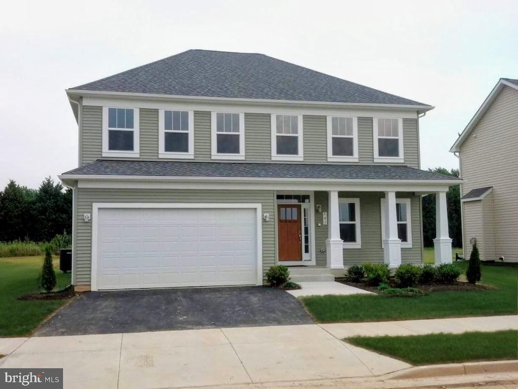541 Conor Dr, Stevensville, MD 21666 - view of front of home with asphalt driveway, a garage, covered porch, and roof with shingles
