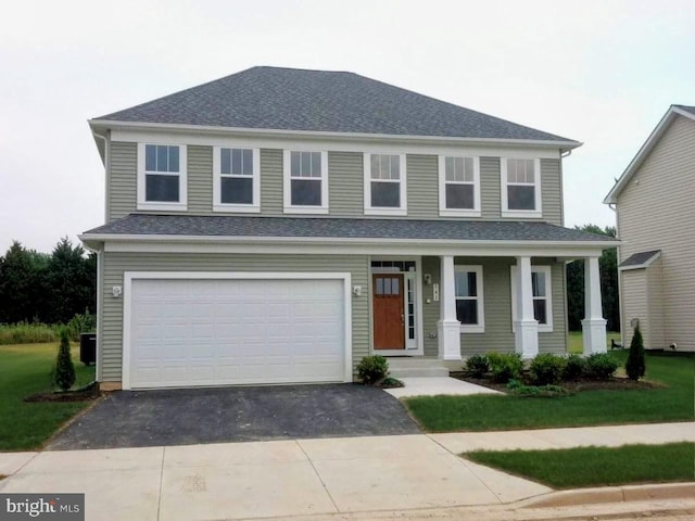 541 Conor Dr, Stevensville, MD 21666 - view of front of home with asphalt driveway, a garage, covered porch, and roof with shingles