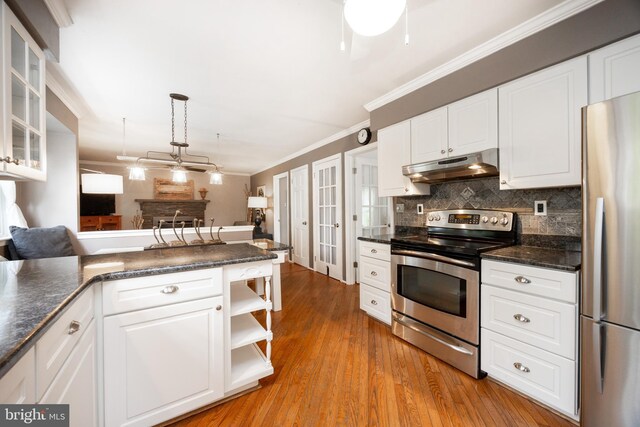 154 Plowshare Rd, Eagleville, PA 19403 - kitchen featuring under cabinet range hood, stainless steel appliances, white cabinetry, crown molding, and tasteful backsplash