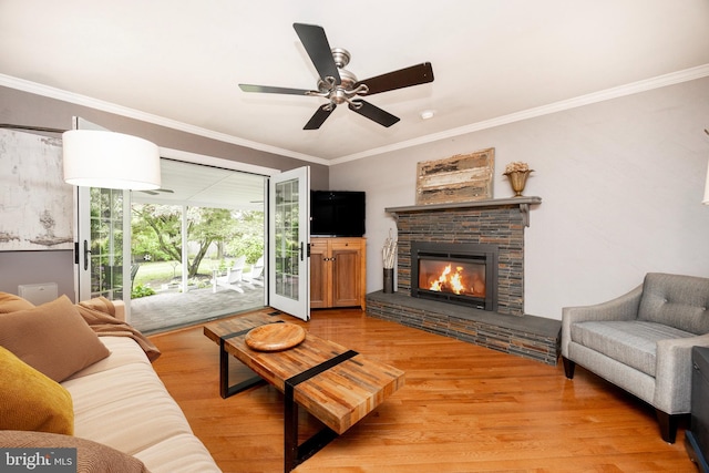 154 Plowshare Rd, Eagleville, PA 19403 - living area with light wood finished floors, a glass covered fireplace, crown molding, and a ceiling fan