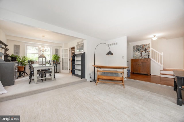 154 Plowshare Rd, Eagleville, PA 19403 - carpeted living area featuring stairs and a chandelier