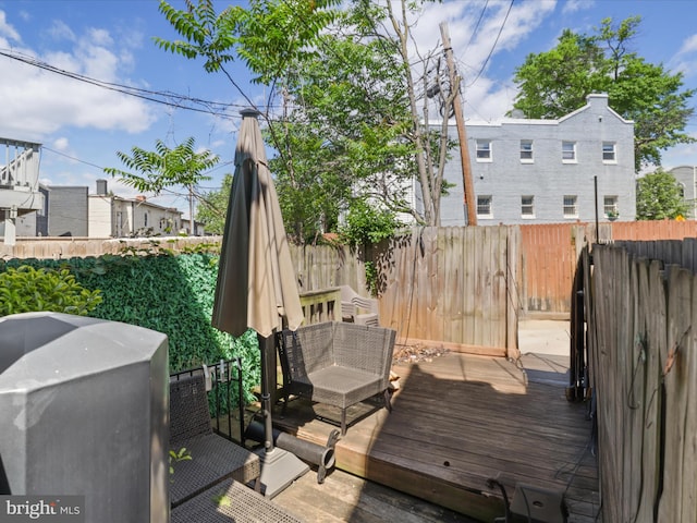 deck featuring a fenced backyard and grilling area