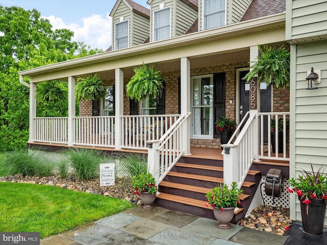 6085 Franklin Gibson Rd, Tracys Landing, MD 20779 - view of exterior entry featuring a porch and stone siding