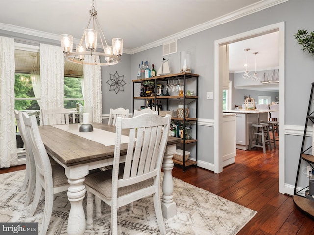 6085 Franklin Gibson Rd, Tracys Landing, MD 20779 - dining area featuring a chandelier, dark wood finished floors, ornamental molding, and healthy amount of natural light