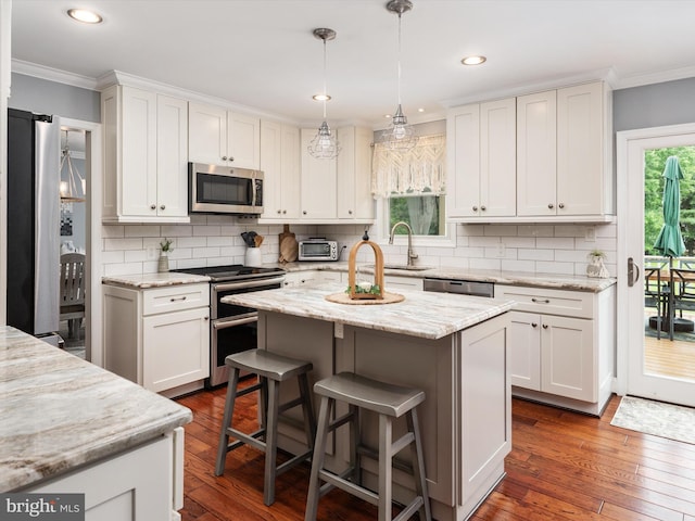 6085 Franklin Gibson Rd, Tracys Landing, MD 20779 - kitchen featuring appliances with stainless steel finishes, ornamental molding, white cabinetry, tasteful backsplash, and recessed lighting