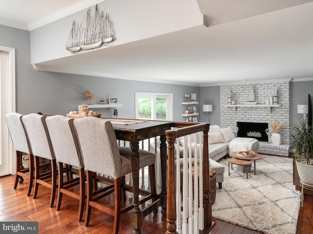 6085 Franklin Gibson Rd, Tracys Landing, MD 20779 - dining space featuring crown molding, wood-type flooring, and a fireplace