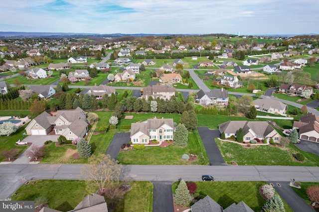 aerial view of property and surrounding area with nearby suburban area
