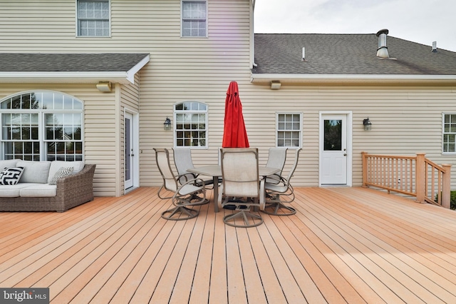 wooden deck featuring outdoor dining area