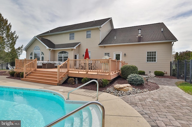 rear view of house featuring fence, a wooden deck, central AC unit, a patio, and an outdoor living space