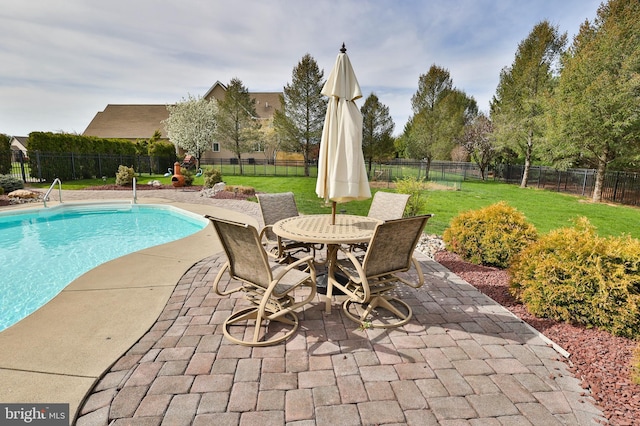 view of swimming pool featuring a patio and outdoor dining space