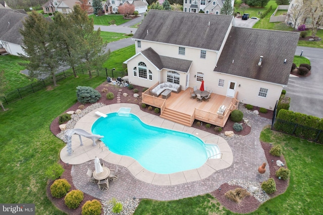 view of pool featuring a wooden deck, a diving board, and a residential view