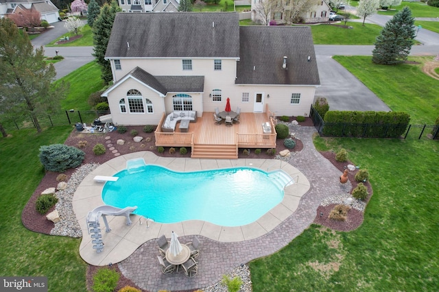 view of pool with a deck, a diving board, and outdoor dining space