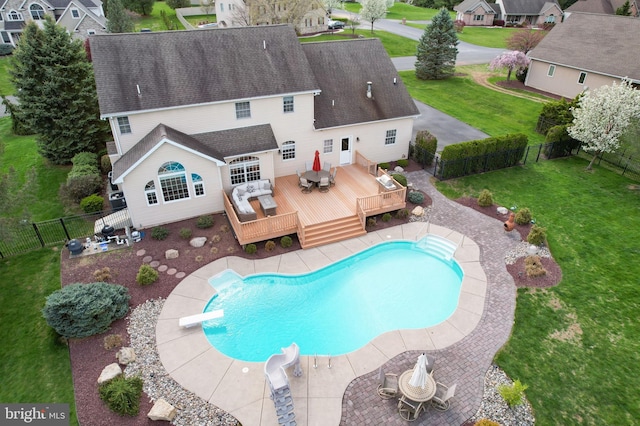 view of swimming pool with a deck and a diving board