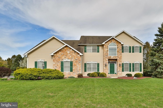 view of front of property featuring stone siding and a front yard
