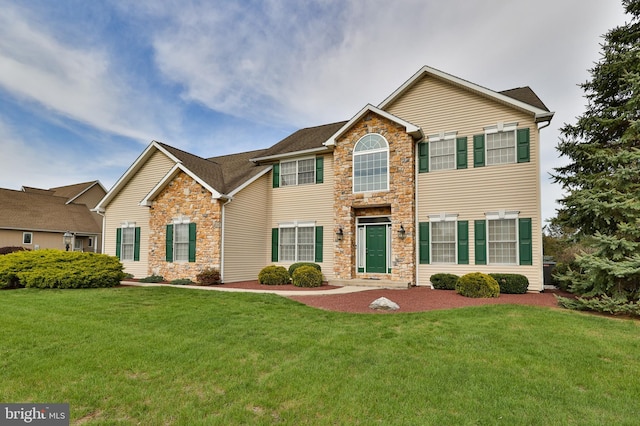 view of front of house with stone siding and a front yard