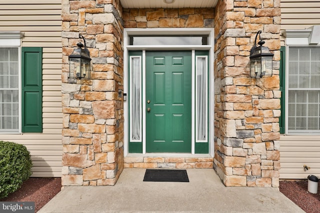 property entrance with stone siding