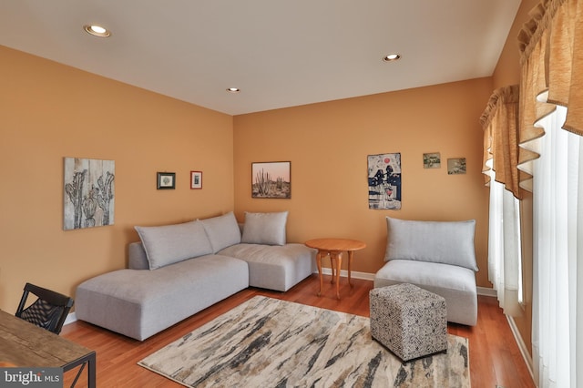 living area with wood finished floors, baseboards, and recessed lighting
