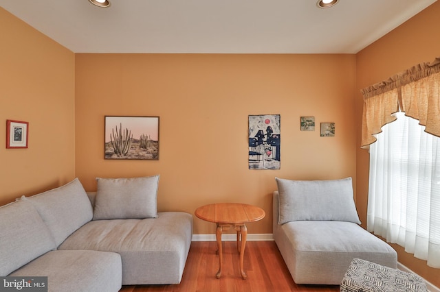 living area with recessed lighting, wood finished floors, and baseboards