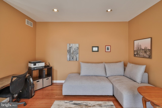 living area featuring recessed lighting, wood finished floors, baseboards, and a desk