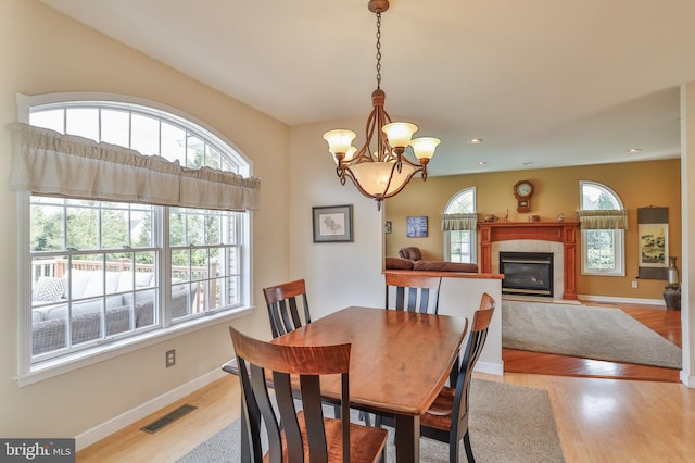 dining area with healthy amount of natural light, light wood-style flooring, and recessed lighting