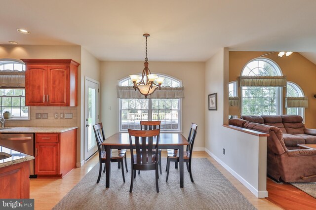 dining space with a chandelier, light wood-type flooring, plenty of natural light, and recessed lighting