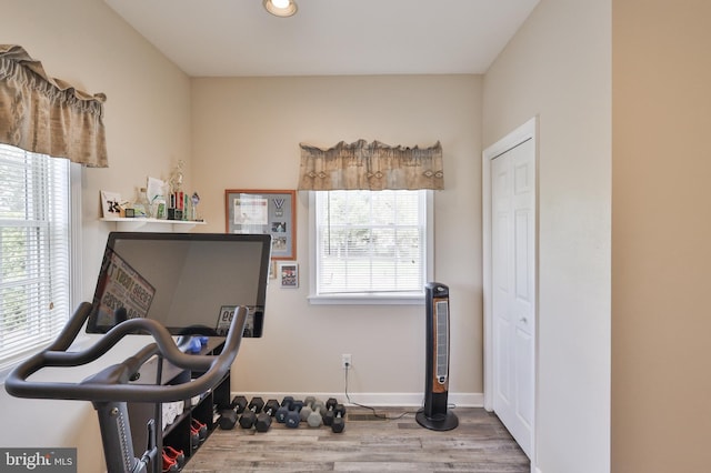 workout room with healthy amount of natural light, wood finished floors, recessed lighting, and baseboards