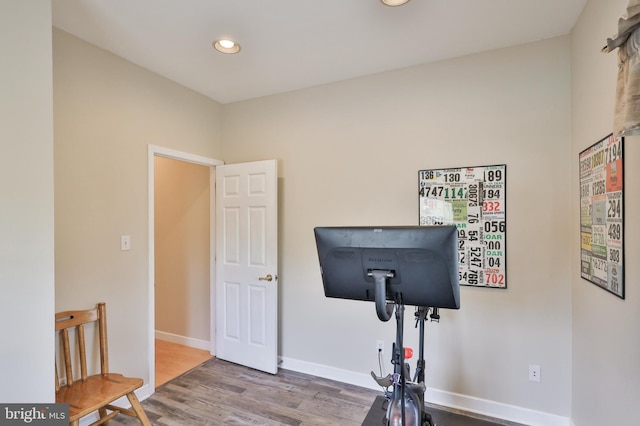 workout room with wood finished floors, recessed lighting, and baseboards