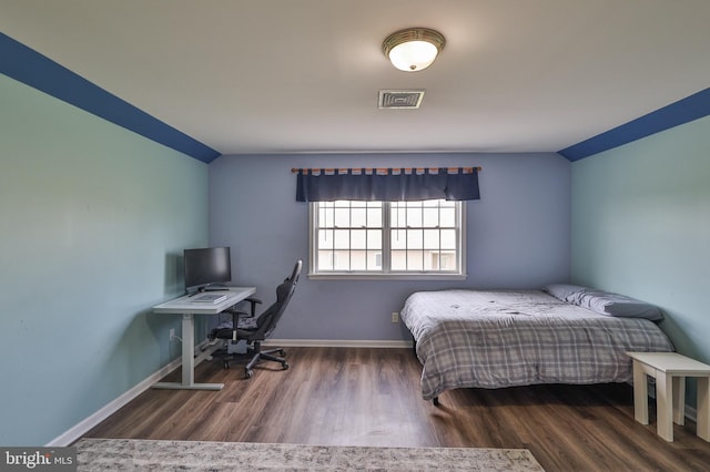 bedroom featuring wood finished floors and baseboards