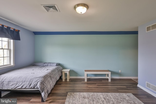bedroom featuring wood finished floors and baseboards