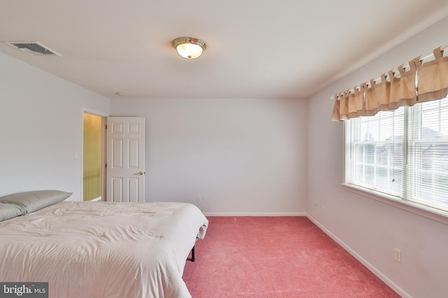 bedroom with light colored carpet and baseboards