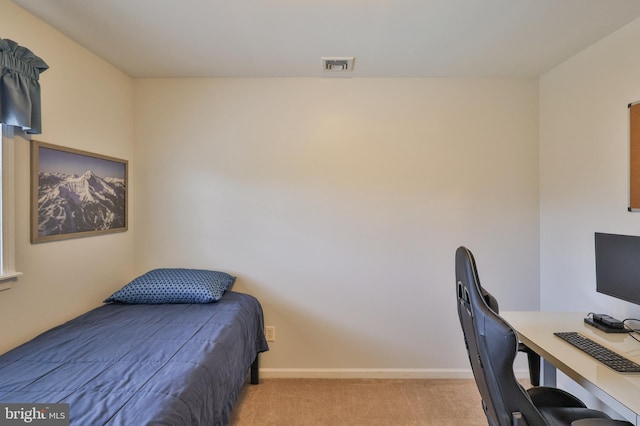 bedroom with light carpet, a desk, and baseboards
