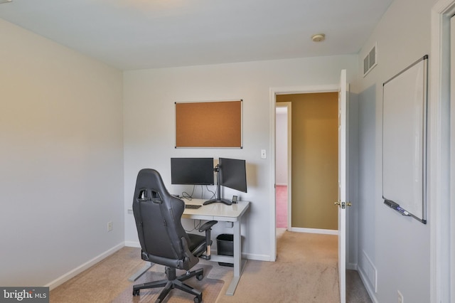 carpeted office featuring baseboards
