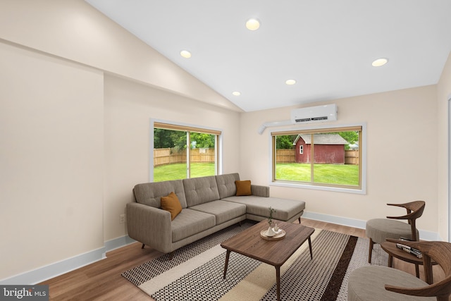 living room with a wall mounted AC, recessed lighting, wood finished floors, lofted ceiling, and baseboards