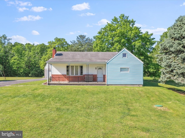 4126 Coseytown Rd, Greencastle, PA 17225 - view of front of house featuring a chimney, a front yard, brick siding, and a porch