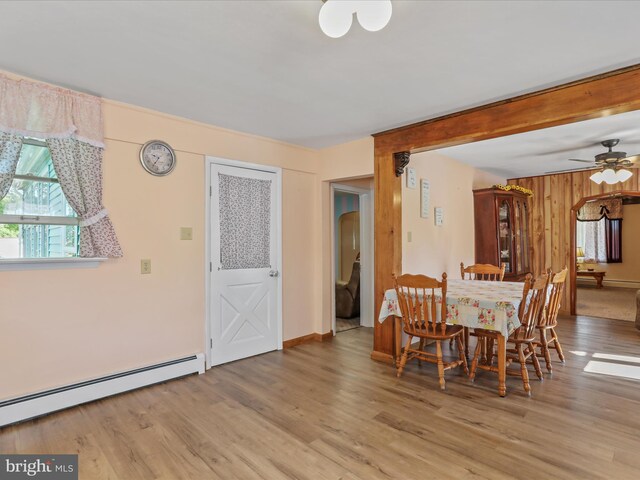 4126 Coseytown Rd, Greencastle, PA 17225 - dining area with a baseboard radiator, light wood finished floors, a ceiling fan, arched walkways, and baseboards