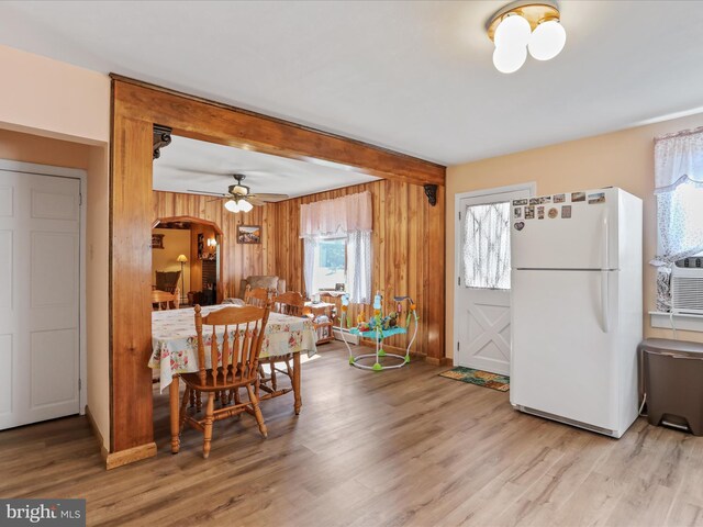 4126 Coseytown Rd, Greencastle, PA 17225 - dining area featuring light wood finished floors, arched walkways, wooden walls, beamed ceiling, and baseboard heating