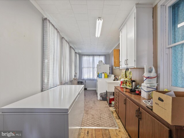 4126 Coseytown Rd, Greencastle, PA 17225 - kitchen featuring washing machine and clothes dryer, light wood-style flooring, refrigerator, baseboards, and light countertops