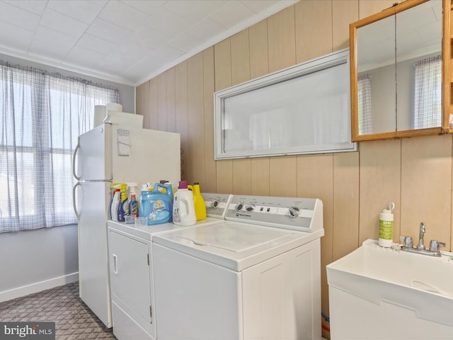 4126 Coseytown Rd, Greencastle, PA 17225 - laundry room featuring separate washer and dryer, wood walls, baseboards, and crown molding
