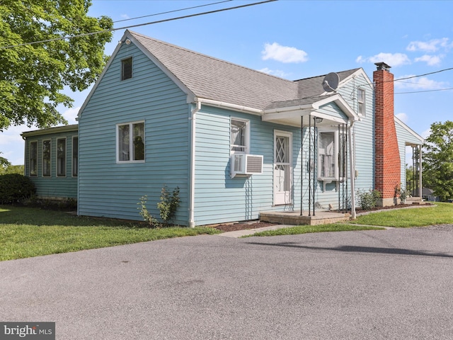 4126 Coseytown Rd, Greencastle, PA 17225 - view of front of home featuring a shingled roof, a front lawn, a chimney, and cooling unit