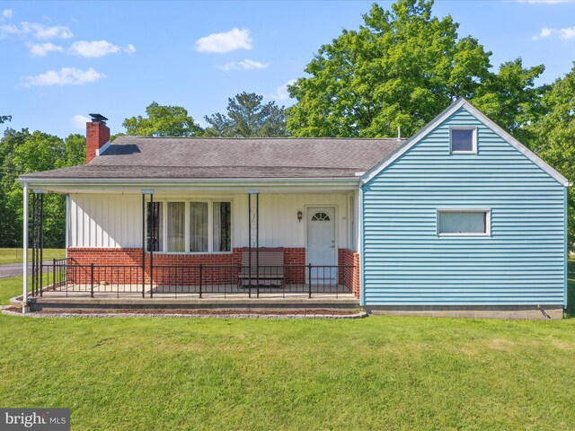 4126 Coseytown Rd, Greencastle, PA 17225 - view of front facade with a chimney, a front lawn, and brick siding
